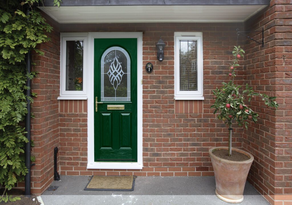 S2V1290.scurrell | GFD Homes front door: Entrance of a home with a green composite door installed.