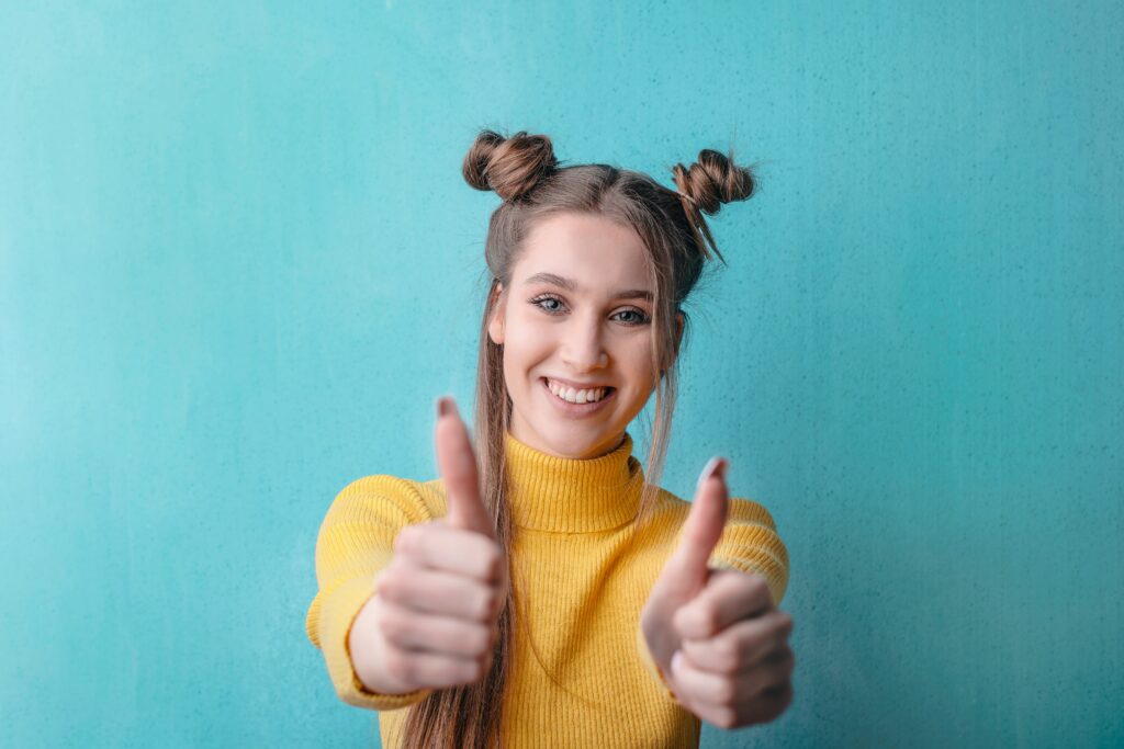 pexels-andrea-piacquadio-3767418 | GFD Homes front door: Woman smiling with thumbs up.