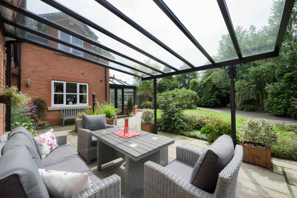 1LB5-7fQ | GFD Homes modern garden ideas: Verandah installed in a patio, with grey garden furniture arranged underneath.