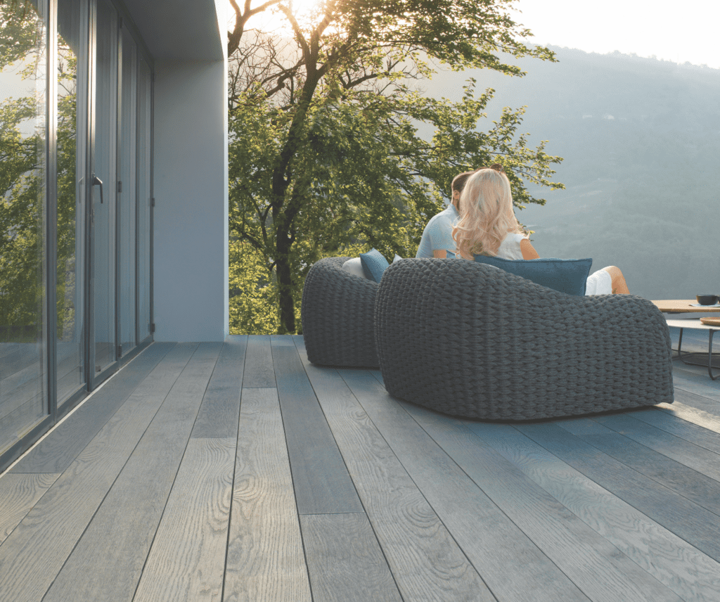 Screenshot-2021-04-26-at-12.32.21 | GFD Homes modern garden ideas: Neutral coloured composite decking installed on a property with furniture arranged on top.