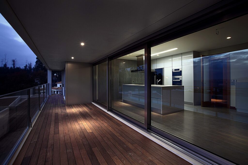 Webp.net-resizeimage9 | GFD Homes sliding patio doors: sliding doors on a balcony, night view.