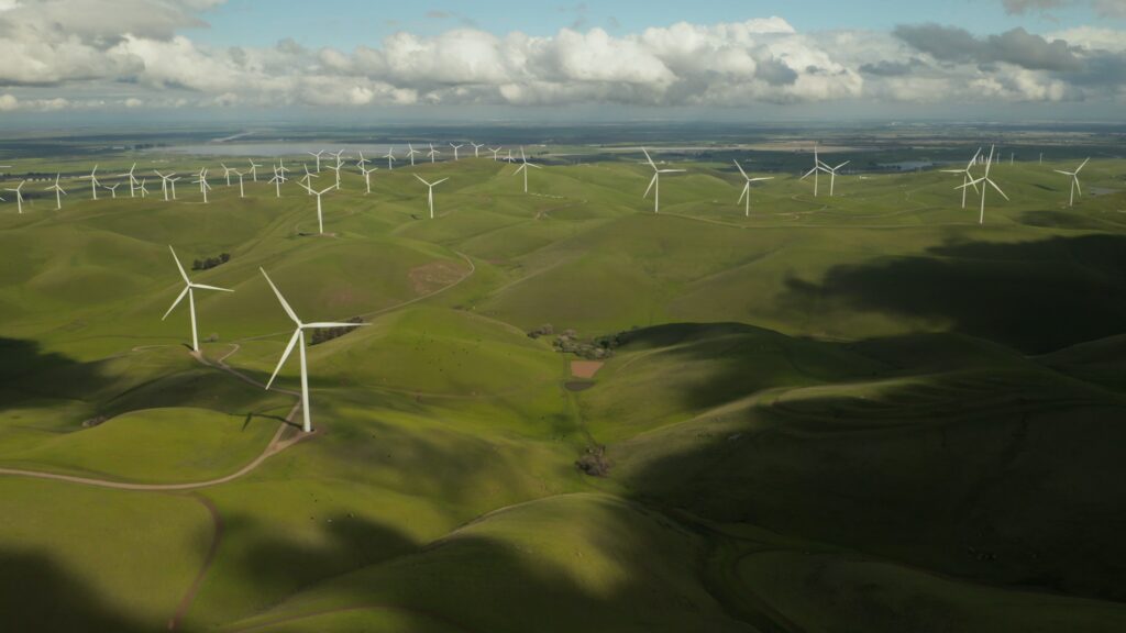 tyler-casey-ficbiwfOPSo-unsplash | GFD Homes building regulations: A range of wind turbines on a large area of green space.