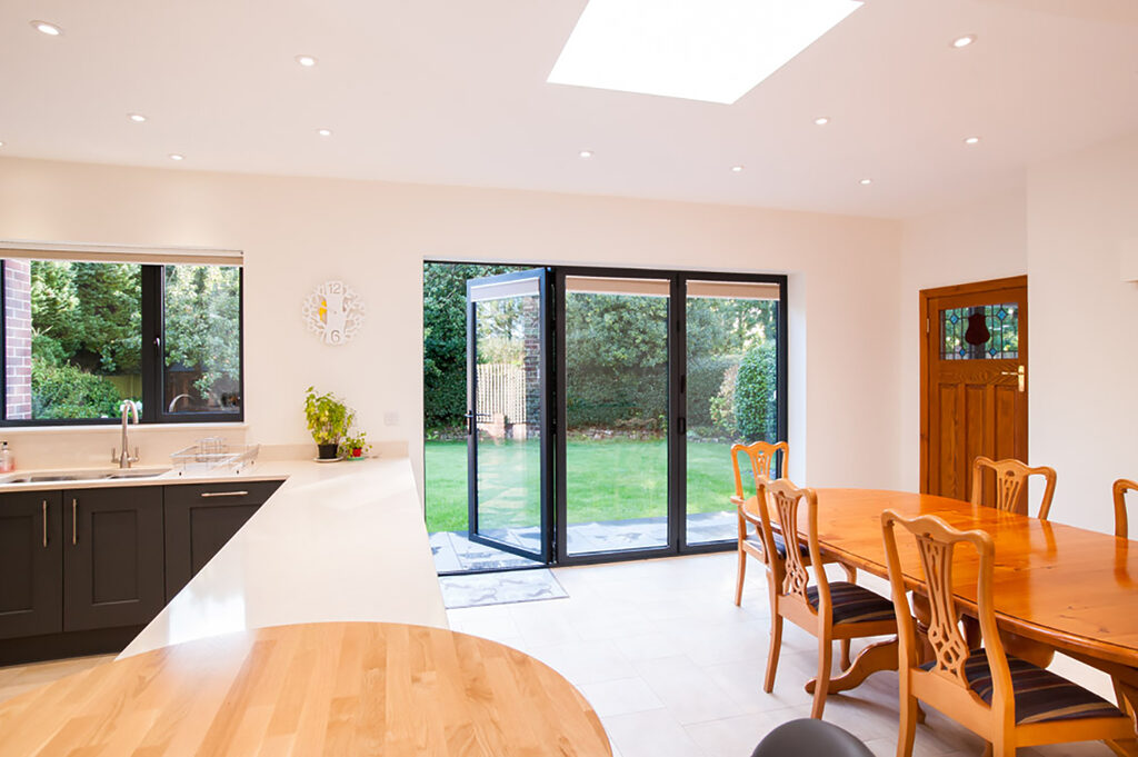 GFD Homes Real Aluminium Bi Fold Doors78 | GFD Homes KItchen with a bifold installed and the traffic door open.