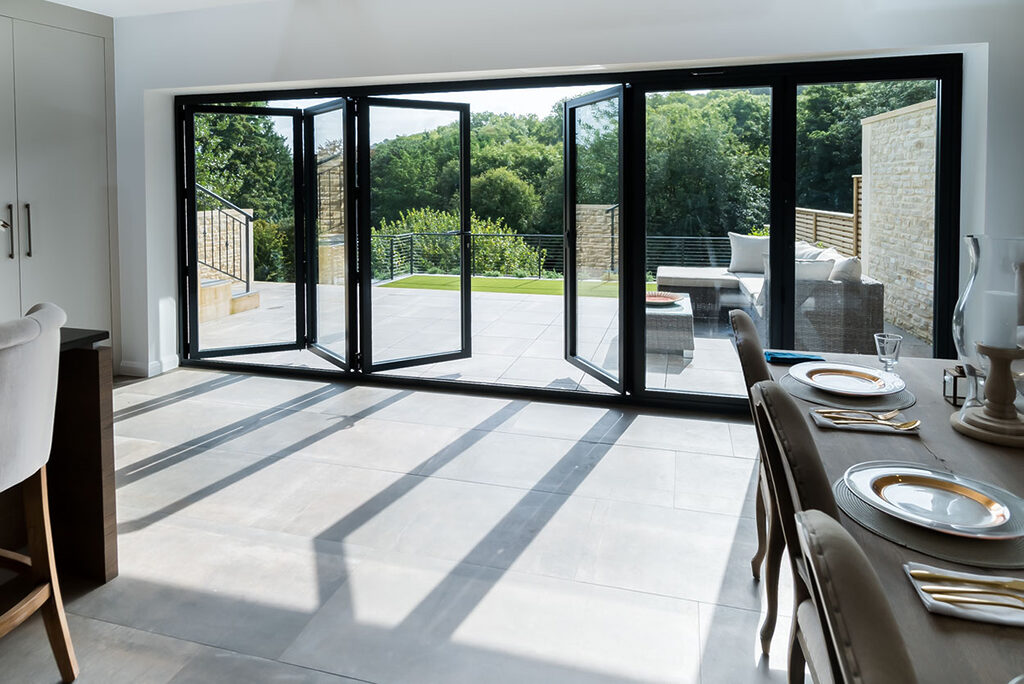 GFD Homes Real Aluminium Bi Fold Doors32 | GFD Homes 6 Panel Smart Bifold door installed as a patio door, half open.