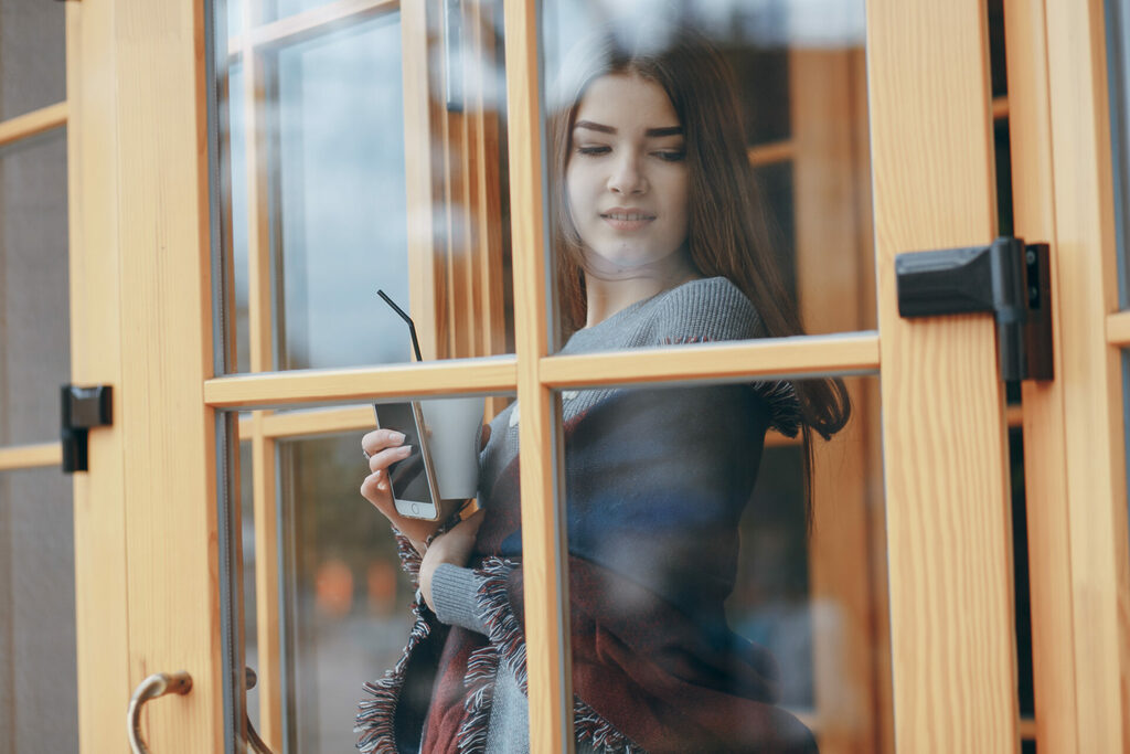 girls in the city | GFD Homes Lady pushing open a double glazed door.