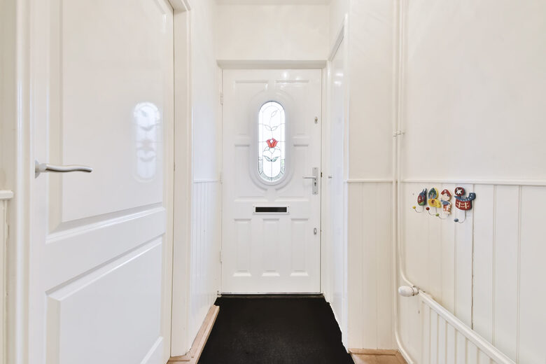 upvc door: looking at white plastic door with internal walls in view also.