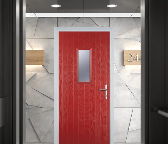 GFD Homes Red front door with a small rectangular window and silver handle, set in a modern gray façade with the number 24 nearby.