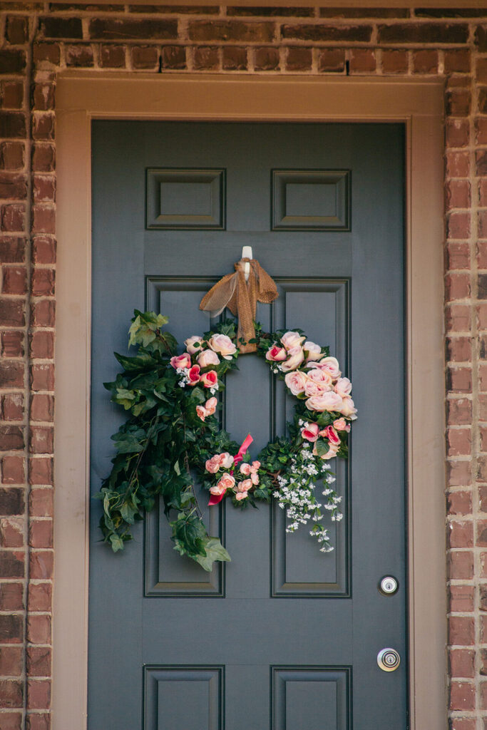 door-with-roses-wreath-for-summer-spring-floral-2024-12-03-15-23-12-utc | GFD Homes draught proofing front door: door with a flower wreath tied to it
