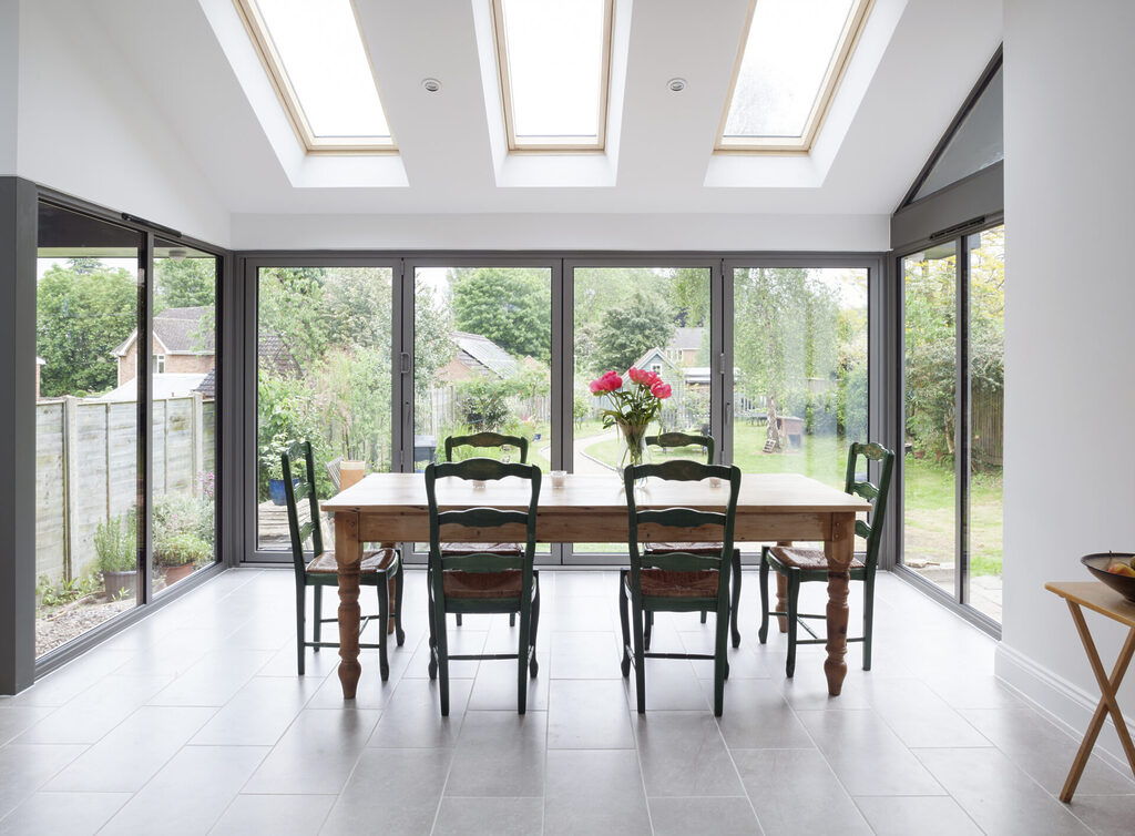 SM 025 001 | GFD Homes what is a trickle vent: bifold doors with dining table infront and roof windows above