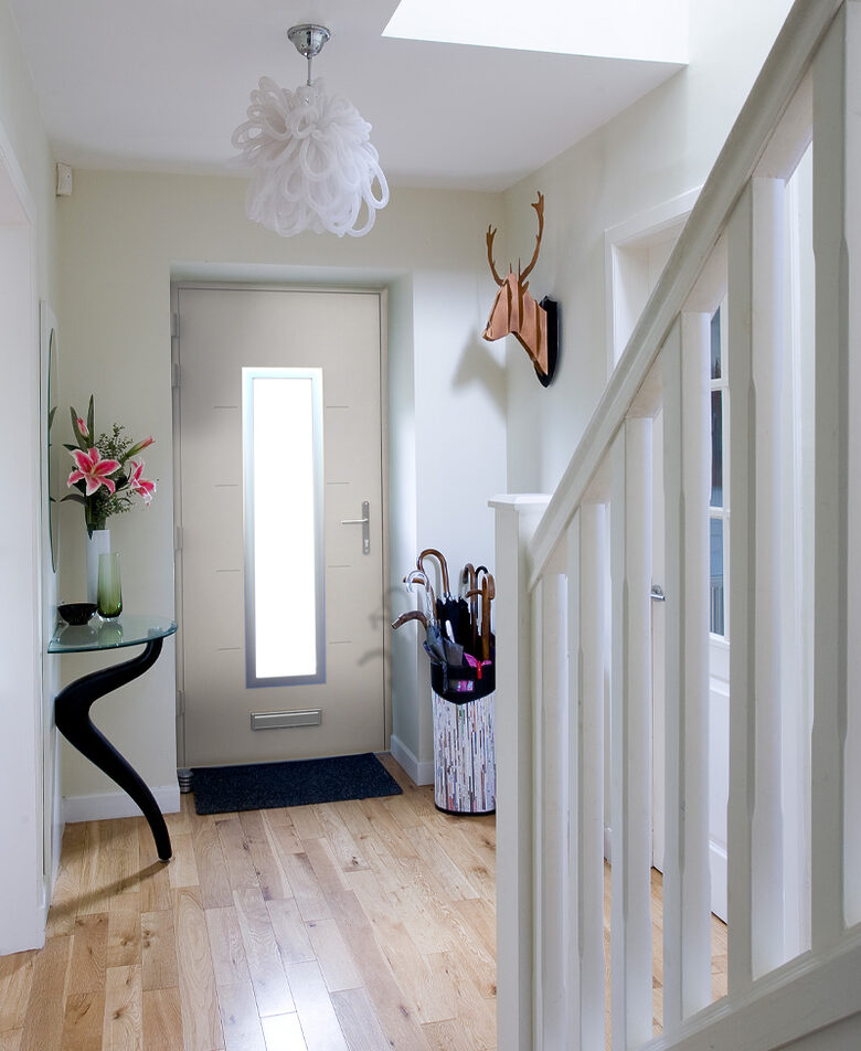 A contemporary exterior entrance featuring a design-led front door that reflects interior colour palettes and material choices.