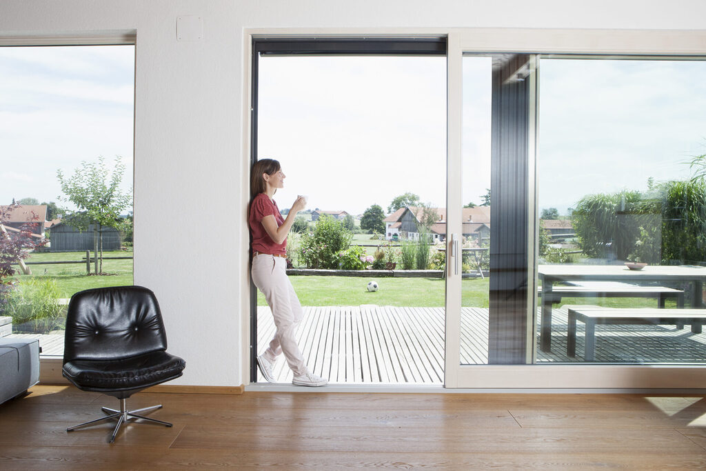energy ratings explained: sliding door open with lady stood in doorway