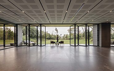 Cortizo aluminium bifold doors and sliding doors opening up a bright, modern living space with slim frames and stunning views