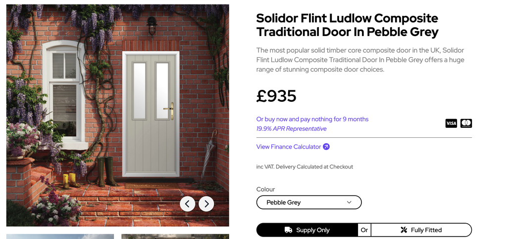 GFD Homes Pebble grey traditional door set in a brick porch with purple flowering vines climbing the walls.