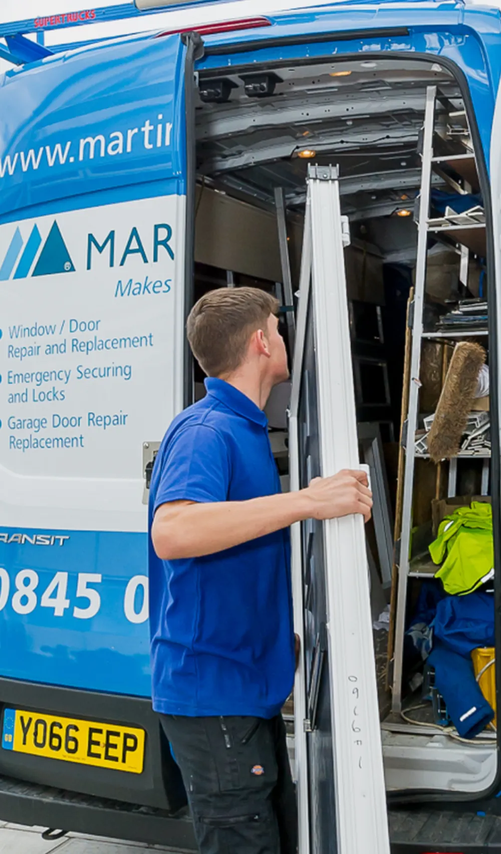 Installer unloading a door frame from a service van
