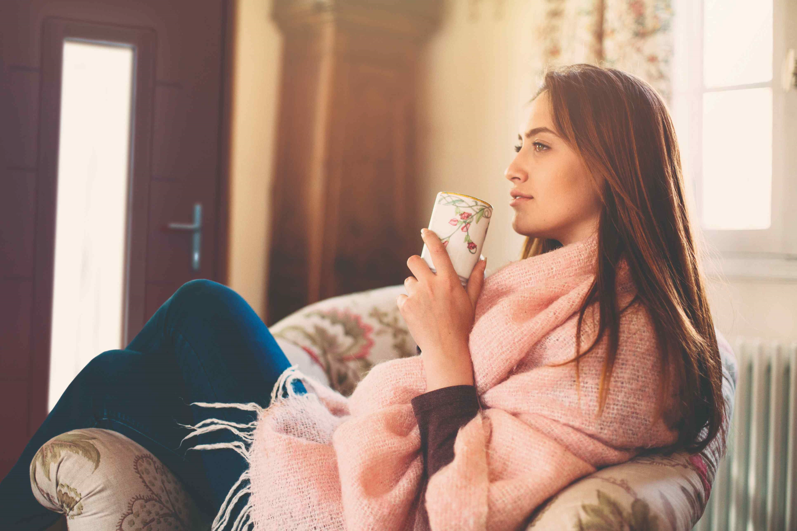 woman drinking coffee on sofa